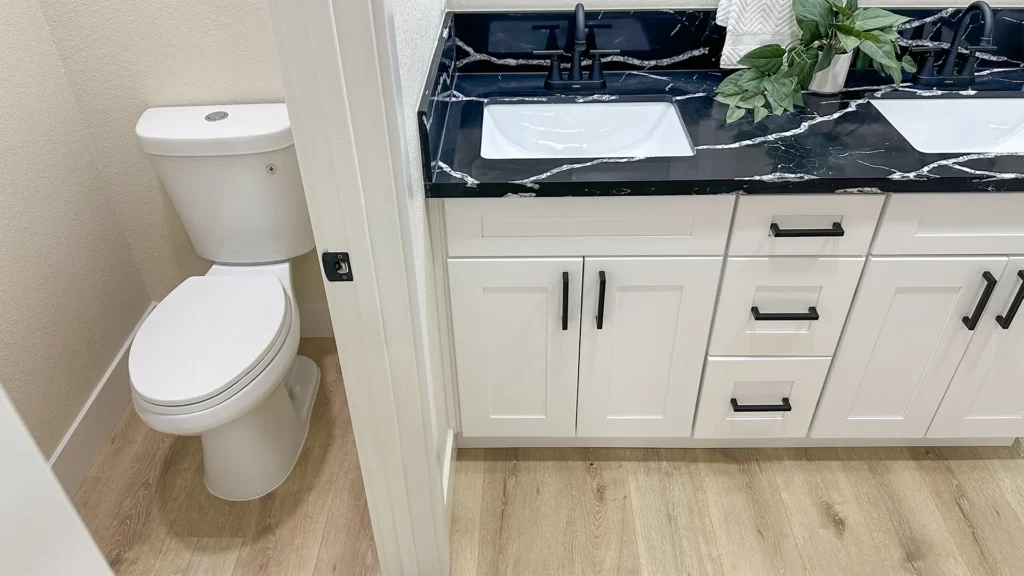 Bathroom remodel featuring new code-compliant plumbing connections for sink toilet and shower systems in Sacramento, CA by Tenax Construction