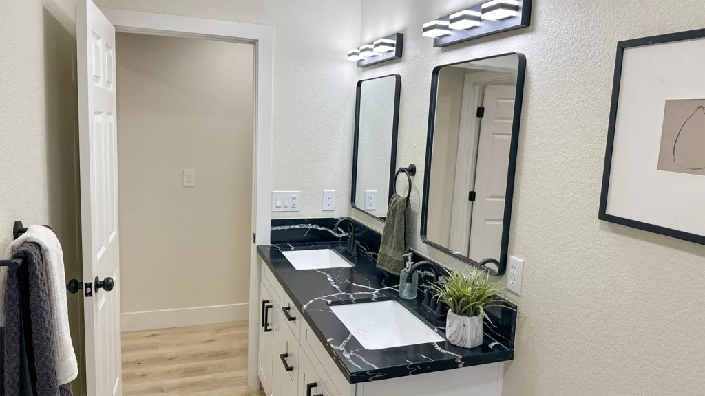 Bathroom remodel featuring new vanity installation connected with updated code-compliant utilities in Sacramento, CA by Tenax Construction