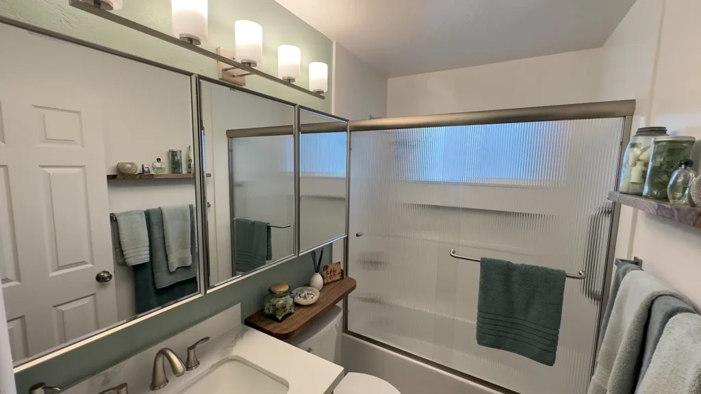 Elegant bathroom remodel featuring completed spa-like bathroom transformation with quartz surround and modern finishes in Fair Oaks, CA by Tenax Construction
