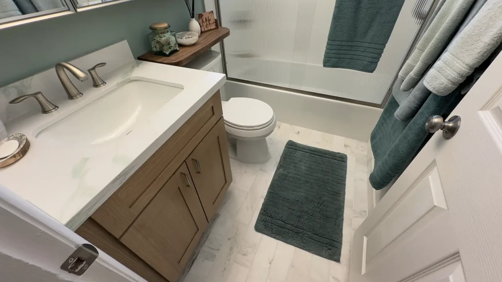 Elegant bathroom remodel featuring soft neutral tones brushed nickel fixtures and natural wood textures throughout in Fair Oaks, CA by Tenax Construction