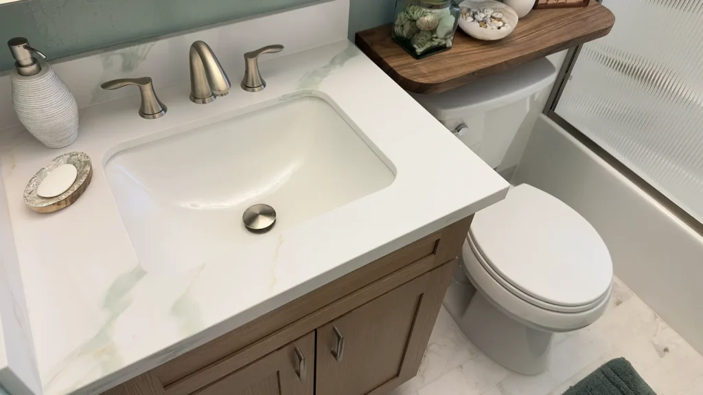 Elegant bathroom remodel featuring custom floating wood shelves adding warmth and natural texture to the space in Fair Oaks, CA by Tenax Construction