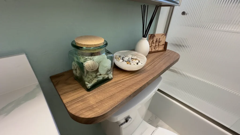 Elegant bathroom remodel featuring durable laminate flooring with coordinating baseboards for seamless look in Fair Oaks, CA by Tenax Construction