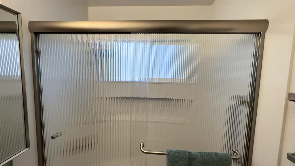 Elegant bathroom remodel featuring new vanity lighting centered above medicine cabinet with advanced vacancy switch in Fair Oaks, CA by Tenax Construction