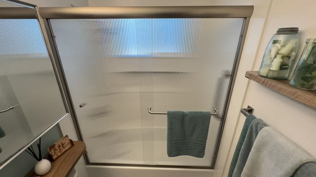 Elegant bathroom remodel featuring new shower valve faucet and toilet connected to existing utilities in Fair Oaks, CA by Tenax Construction