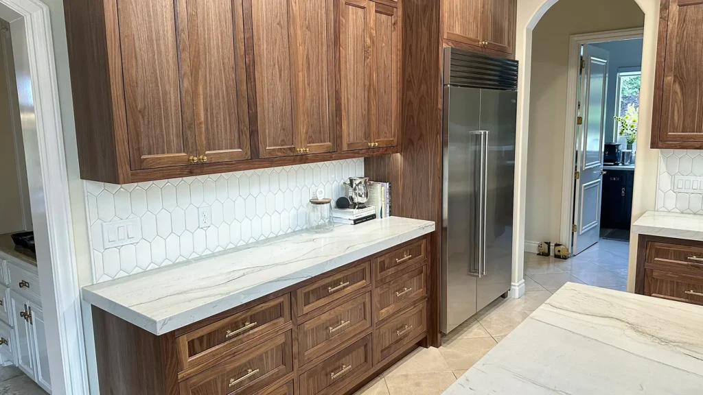 Elegant kitchen remodel featuring deepened range wall cabinets with discreet pull-outs framing cooktop in Granite Bay, CA by Tenax Construction