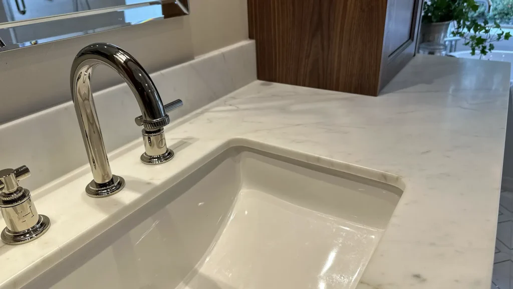 Luxury bathroom remodel featuring custom vanity with marble countertops and integrated sinks in Granite Bay, CA by Tenax Construction