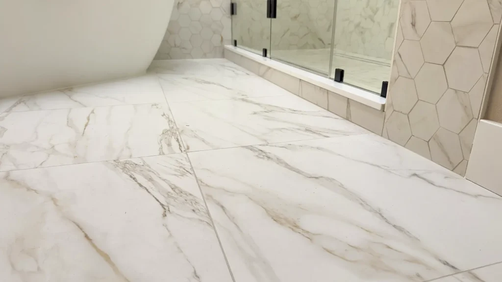 Luxury primary bathroom remodel featuring large dual-function walk-in shower with hex tile surround in Gold River, CA by Tenax Construction