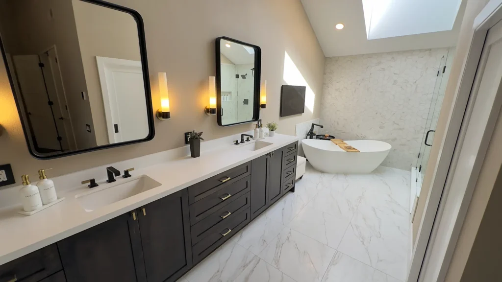 Luxury primary bathroom remodel featuring frameless glass shower doors with black brackets and open spa feel in Gold River, CA by Tenax Construction