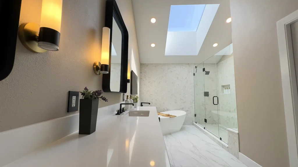 Luxury primary bathroom remodel featuring 125-inch ebony-stained double-sink vanity with brass hardware and quartz countertops in Gold River, CA by Tenax Construction