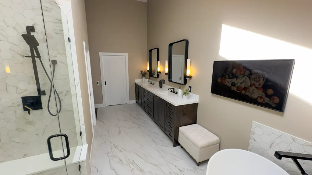Luxury primary bathroom remodel featuring hexagonal marble tile on shower and tub walls with custom niches in Gold River, CA by Tenax Construction