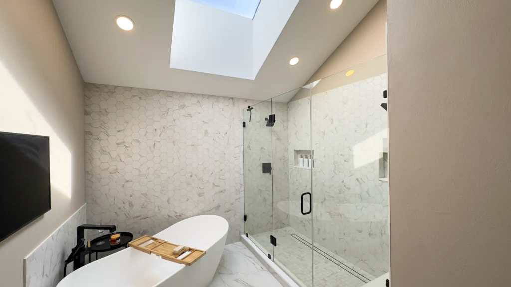Luxury primary bathroom remodel featuring removal of raised flooring and closet partitions for improved flow in Gold River, CA by Tenax Construction