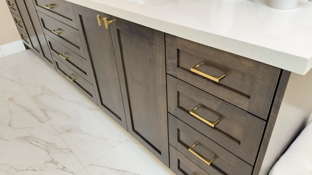 Luxury primary bathroom remodel featuring custom vanity with abundant storage and modern brass hardware detail in Gold River, CA by Tenax Construction