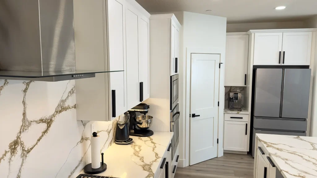 Modern luxury kitchen remodel featuring built-in double ovens and modern range in chef's kitchen layout in Roseville, CA by Tenax Construction