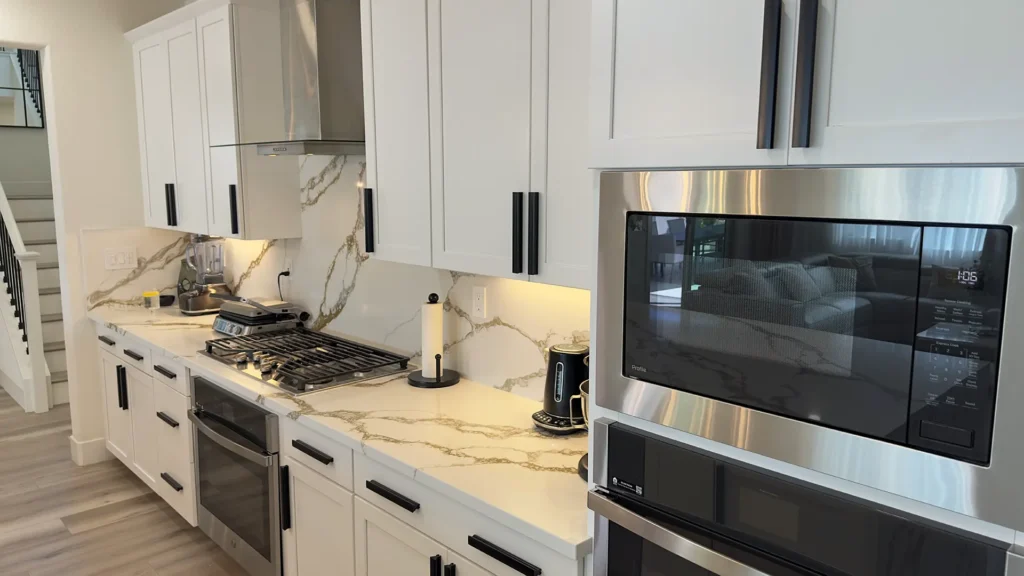 Modern luxury kitchen remodel featuring integrated dishwasher and optimized storage throughout kitchen in Roseville, CA by Tenax Construction