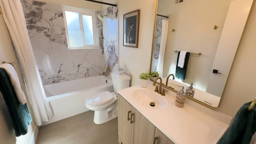 Bathroom remodel featuring completed bathroom with premium finishes custom doors and quartz walls in Fair Oaks, CA by Tenax Construction
