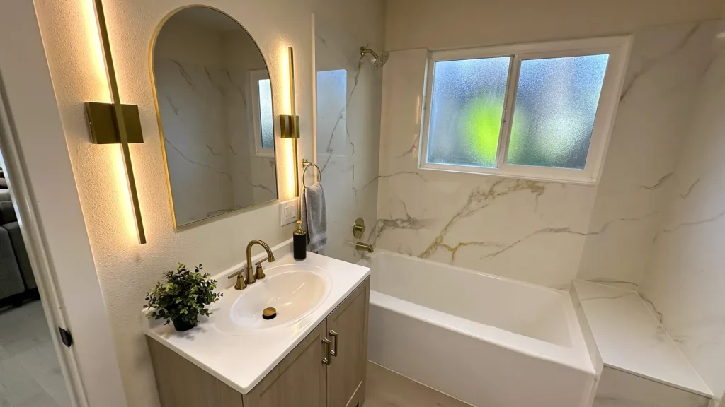 Bathroom remodel featuring new bathtub installation with sliding tub doors and modern plumbing fixtures in Fair Oaks, CA by Tenax Construction