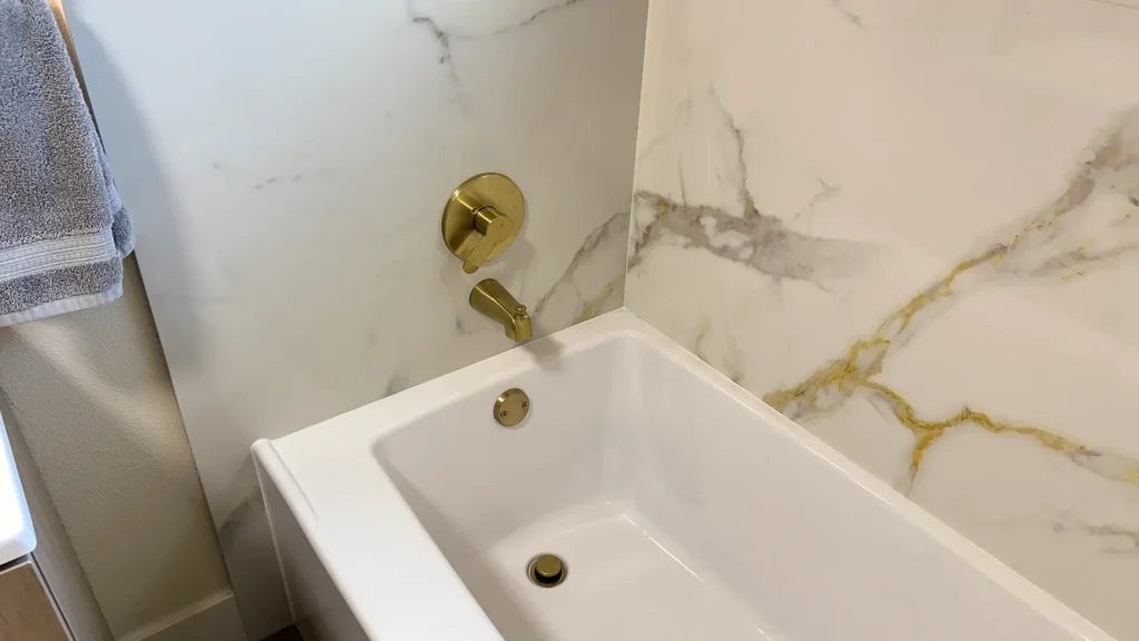 Bathroom remodel featuring guest bathroom renovation with concrete slab demolition and plumbing re-route in Fair Oaks, CA by Tenax Construction