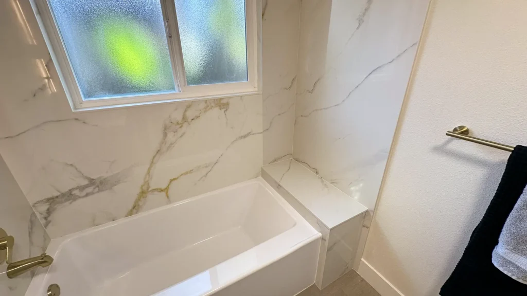 Bathroom remodel featuring new vanity light mirror and toilet installation for powder room update in Fair Oaks, CA by Tenax Construction