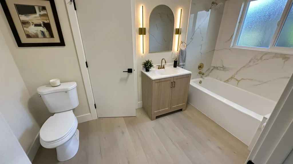 Bathroom remodel featuring half bathroom refresh with new 18-inch vanity cabinet for compact storage in Fair Oaks, CA by Tenax Construction