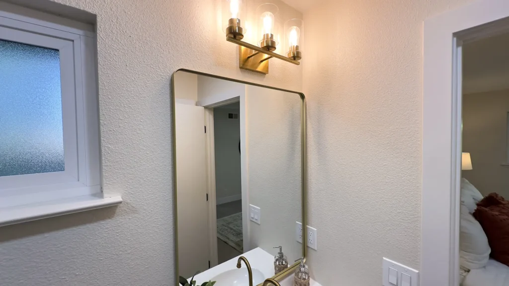 Bathroom remodel featuring new 39-inch vanity cabinet with modern faucet and vanity lighting in Fair Oaks, CA by Tenax Construction