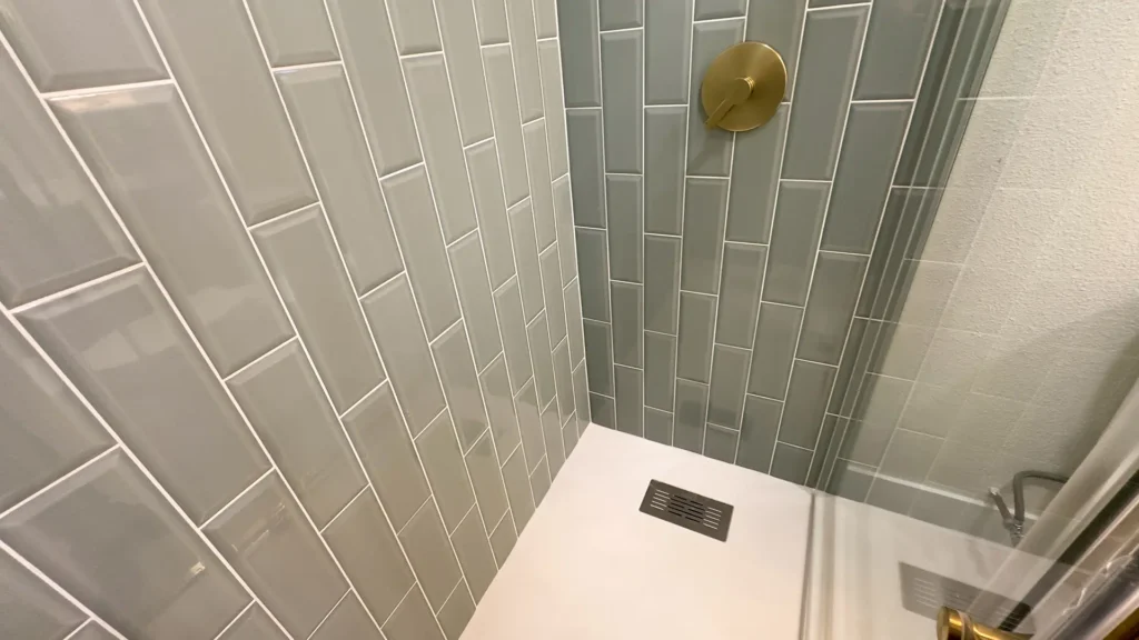 Bathroom remodel featuring Castico shower pan installation with slider shower doors and new valve trim in Fair Oaks, CA by Tenax Construction