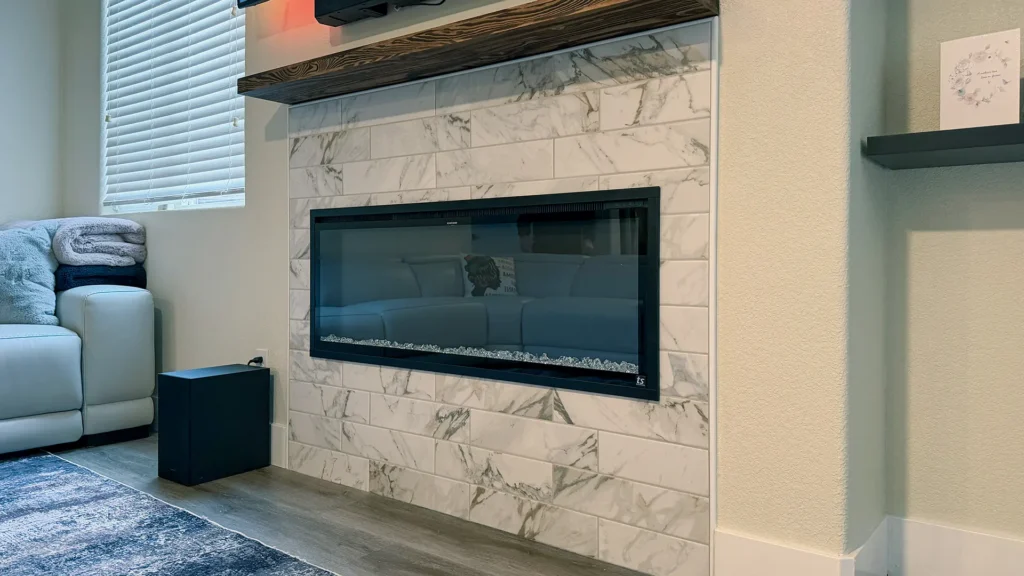 Full kitchen remodel and fireplace conversion featuring completed living area with electric fireplace TV wall and modern finishes in Elk Grove, CA by Tenax Construction