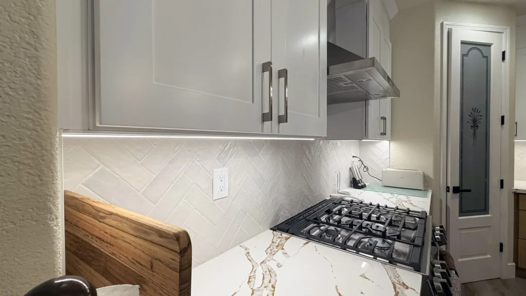 Full kitchen remodel featuring white quartz countertops with gray veining and 42-inch island for prep and seating in Elk Grove, CA by Tenax Construction