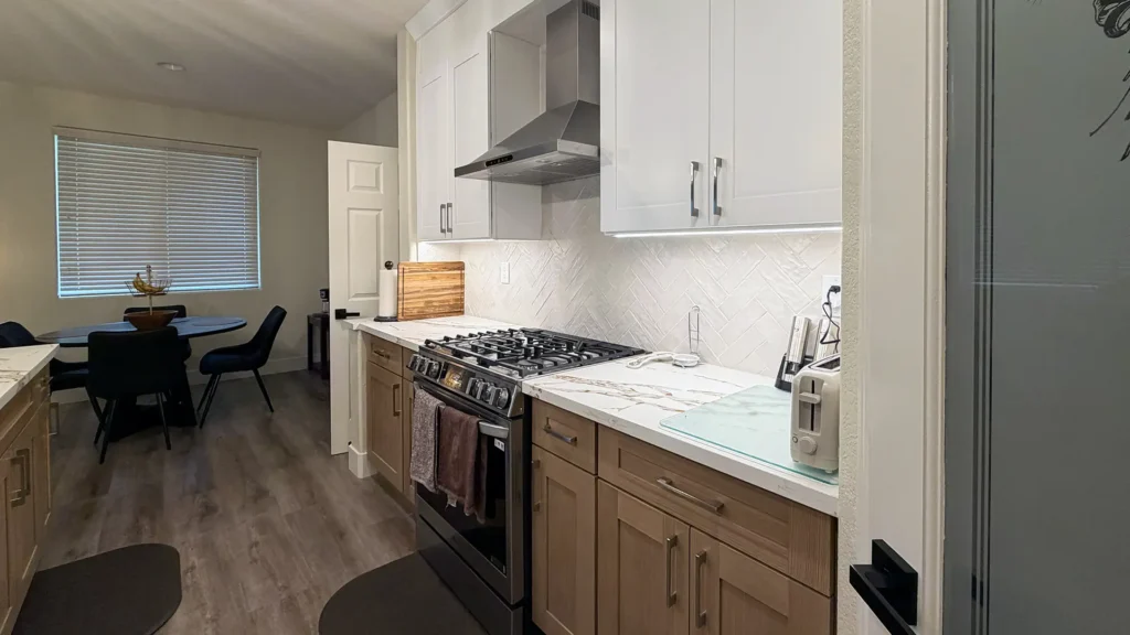 Full kitchen remodel featuring shaker-style white wall cabinets and light gray base cabinets in two-tone layout in Elk Grove, CA by Tenax Construction