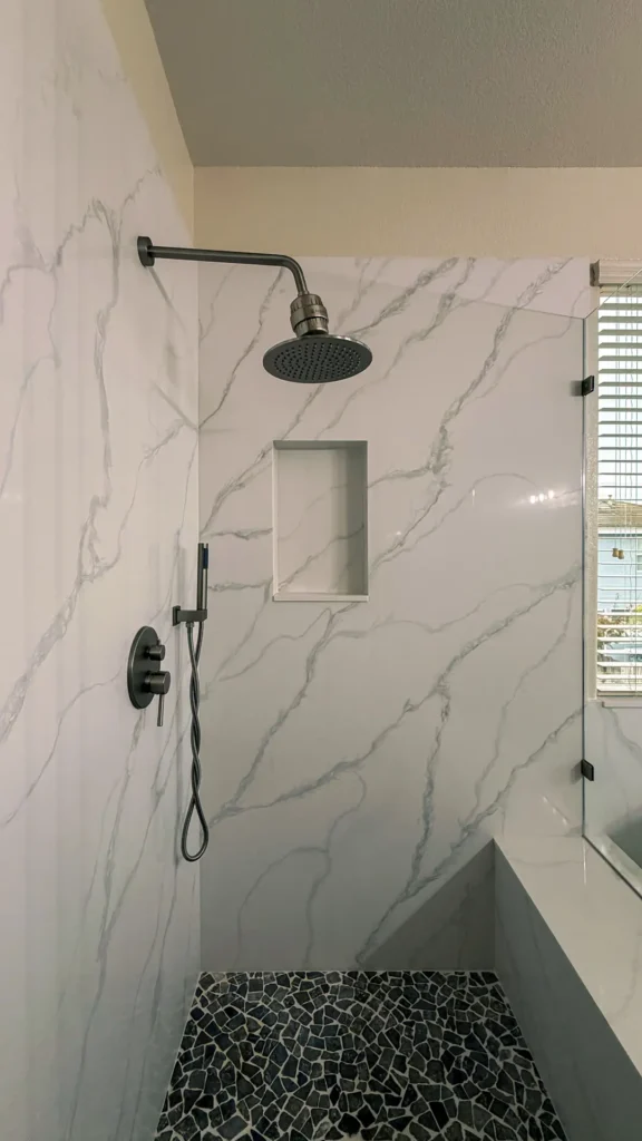 Spa-like master bathroom remodel featuring two 14x22 inch shower niches and tiled shower pan for storage and drainage in Elk Grove, CA by Tenax Construction