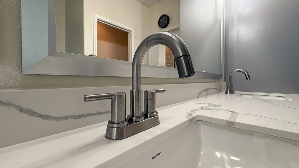 Spa-like master bathroom remodel featuring new lighting fixtures towel bars and mirrors throughout updated bathroom in Elk Grove, CA by Tenax Construction