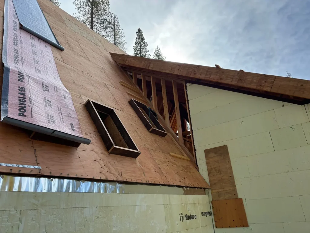 ICF mountain home construction featuring snow-ready drainage and gutter systems on exterior in Soda Springs, CA by Tenax Construction