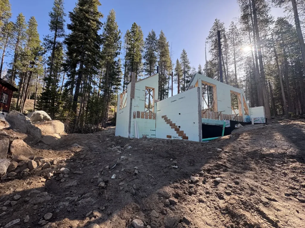 ICF mountain home construction featuring standing-seam metal roof rated for heavy Sierra Nevada snow loads in Soda Springs, CA by Tenax Construction