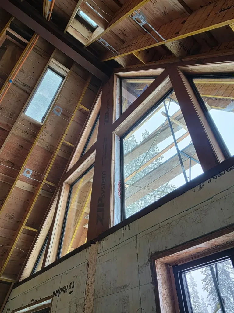 ICF mountain home construction featuring completed Mountain Modern exterior with metal roof and board and batten siding in Soda Springs, CA by Tenax Construction