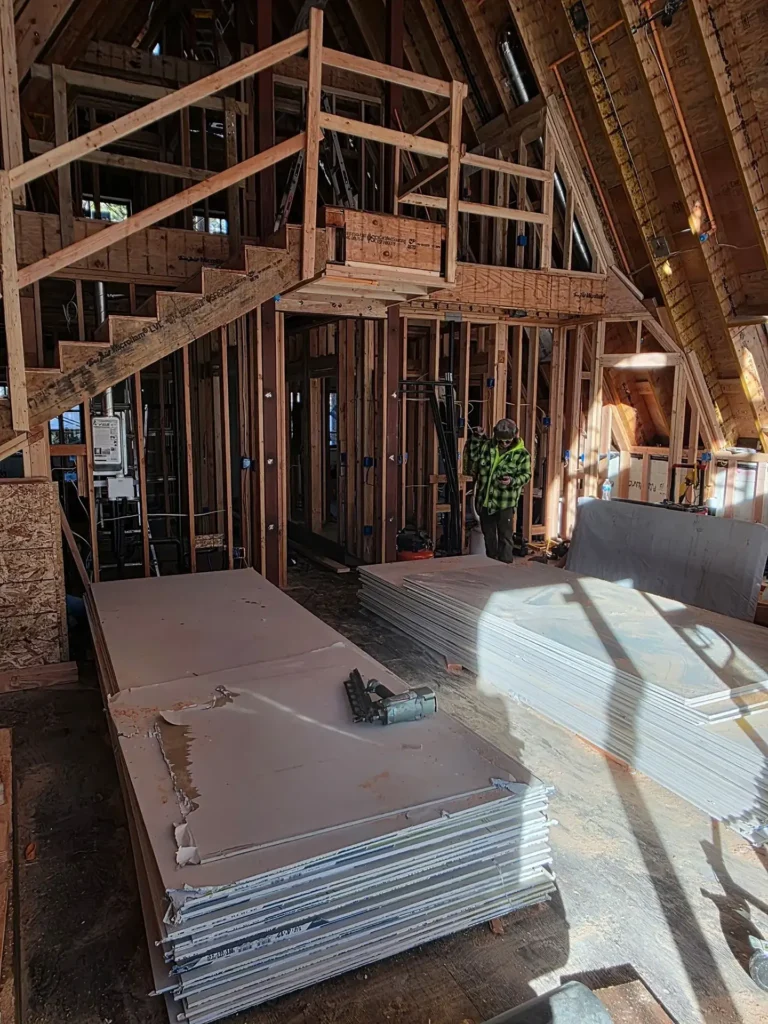 ICF mountain home construction featuring exterior deck framing and cable railing system installation in Soda Springs, CA by Tenax Construction