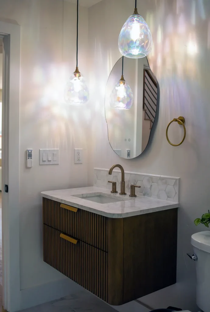 Full bathroom remodel featuring updated vanity mirror lights and toilet in guest bathroom in Sacramento, CA by Tenax Construction