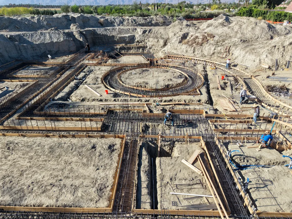Luxury ICF custom home construction featuring custom-formed concrete staircase integrated with ICF walls in Indio, CA by Tenax Construction