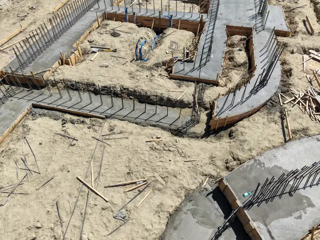 Luxury ICF custom home construction featuring foundation concrete pour with dual pump trucks in Indio, CA by Tenax Construction