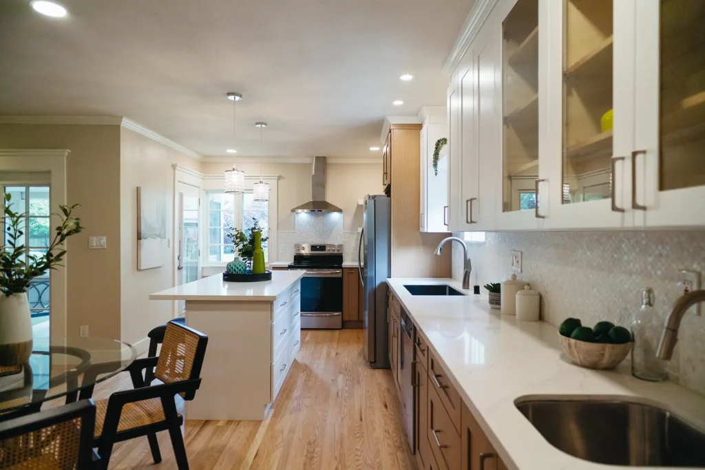 Complete kitchen remodel featuring recessed can lighting and pendant lights above bar area in Sacramento, CA by Tenax Construction