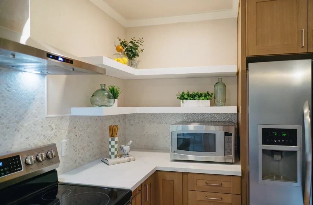 Complete kitchen remodel featuring decorative open shelving for storage and display in Sacramento, CA by Tenax Construction